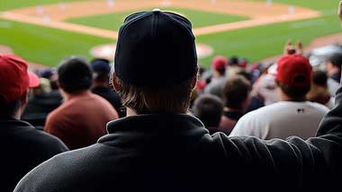 photo taken behind man watching baseball game