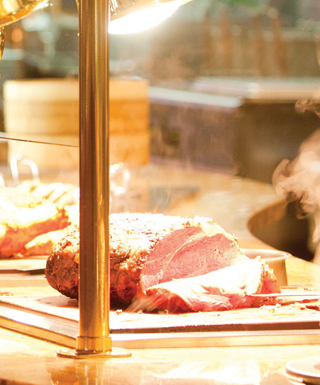 A woman and man carry full plates away from the Epic Buffet at Hollywood Casino in Toledo, Ohio.