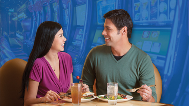 A young couple enjoys a meal at the Epic Buffet.